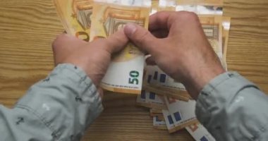 Mens hands count money, cash euro. Top view from the first person. Concept of getting a salary, credit, work, taxes, finance, payment for services, high price. High quality 4k footage