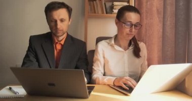 Office workers celebrate success. Desktop, front view, laptops. They rejoice with their hands, waving, fists. High quality 4k footage