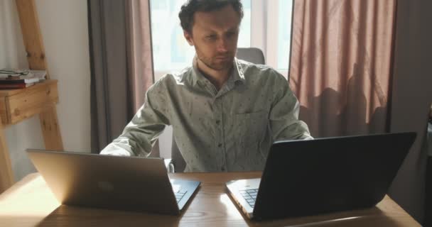 Young Specialist Works Two Laptops Same Time Front View Portrait — Stockvideo