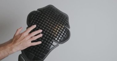 Dismantling the back protection for a motorcycle jacket. Plastic plate with flexible squares. High quality 4k footage