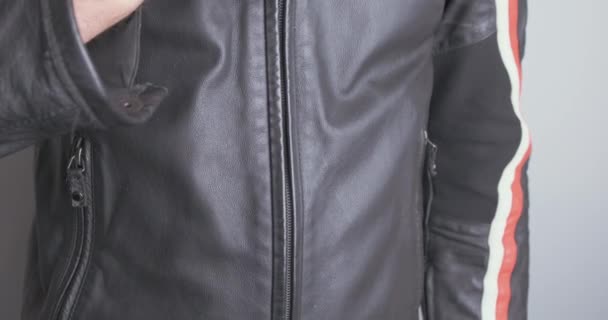 Man Unzips Black Leather Jacket Close Chest Front View High — Vídeos de Stock