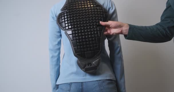 Man Tries Plastic Back Protector Motorcycle Jacket Woman Standing Her — Stok video