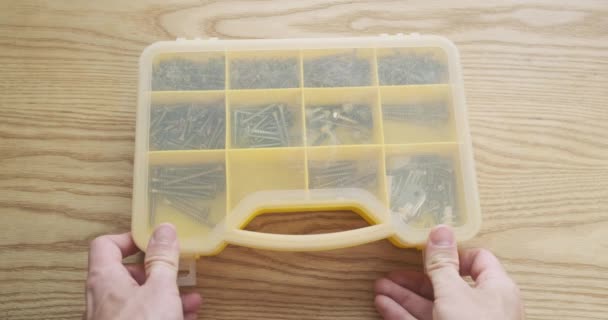 Mans Hand Opens Plastic Box Screws Selects Desired Screw First — Stockvideo