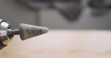 Rotation of the stone grinding head in an electric screwdriver. Rapid movement of the drill, side view, close-up. High quality 4k footage
