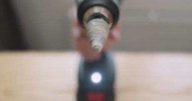 Rotation of the stone grinding head in an electric screwdriver. Rapid movement of the drill, side view, close-up. High quality 4k footage
