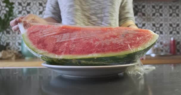 Girl Removes Transparent Wrapper Large Piece Red Juicy Watermelon Lying — Vídeo de Stock