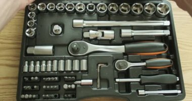 Man closes a plastic case with a set of ratchet sockets, socket wrenches, bits. A set of tools. First-person view. High quality 4k footage