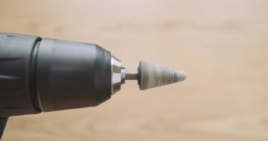 Rotation of the stone grinding head in an electric screwdriver. Rapid movement of the drill, side view, close-up. Working electric screwdriver. High quality 4k footage