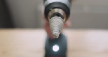 Rotation of the stone grinding head in an electric screwdriver. Starting the rotation of the grinding bit. Rapid movement of the drill, front view, close-up. High quality 4k footage