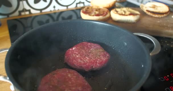 Two Burger Patties Fried Black Frying Pan Close Side View — Videoclip de stoc