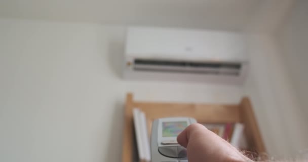 Mans Hand Turns Air Conditioner Using Remote Control Close Blurred — 图库视频影像