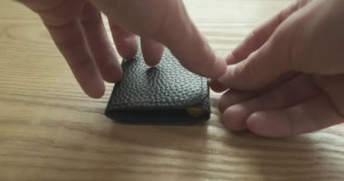 Male hands open a case with a set of mini screwdrivers with bits lying on a wooden table. The concept of the beginning of the work of a craftsman, repair of electronics, mobile phones. High quality 4k