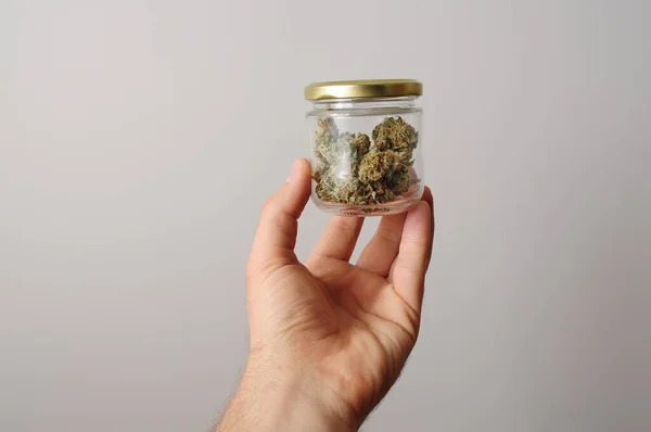 Cam kavanozda esrar tomurcukları. Eko depolama. Tıbbi marihuana kullanımı. Kenevir rekreasyonu, eğlence konsepti. 