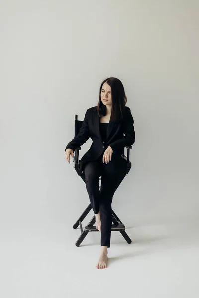 Girl Black Suit White Background Sits Chair — Foto Stock
