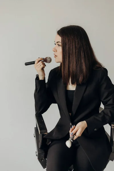 Girl Black Suit Brush Her Hands White Background Sits Chair — 스톡 사진