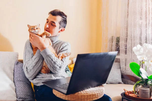 Man Working Internet Home Holding Cat Using Laptop Young Freelancer — Stock Fotó