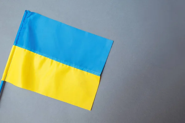 Крупный план украинского сине-желтого флага на сером фоне. Нарастание вторжения на Украину. Нет войны.. — стоковое фото