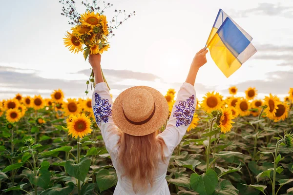 Back View Happy Woman Raising Arms Ukrainian Flags Bouquet Sunflowers — стоковое фото