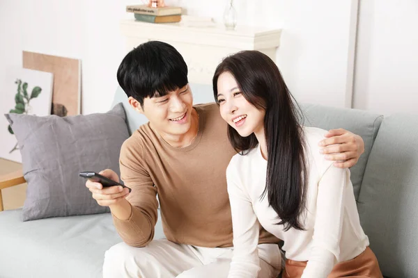 Asian Korean Couple Sofa Watching Holding Remote Controller — 图库照片