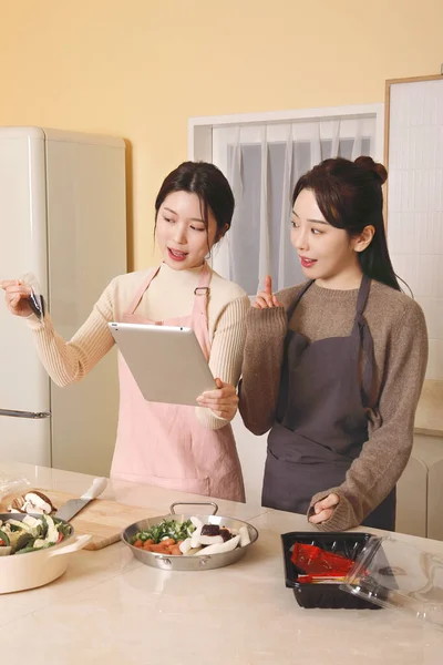 アジア系韓国人女性がタブレットで料理をしたりストリーミングしたり — ストック写真