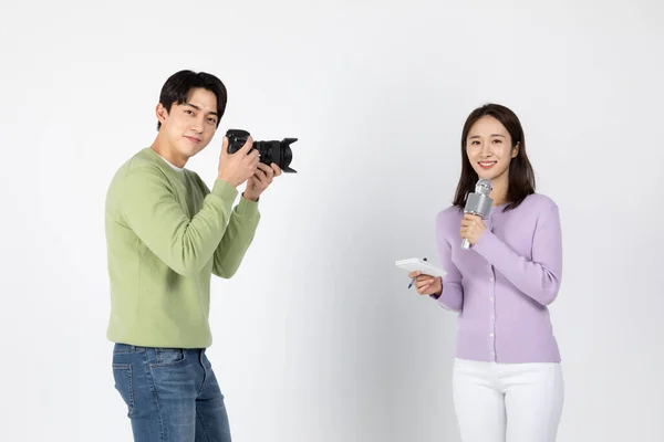 job interview preparation asian korean young woman and man, holding camera and microphone