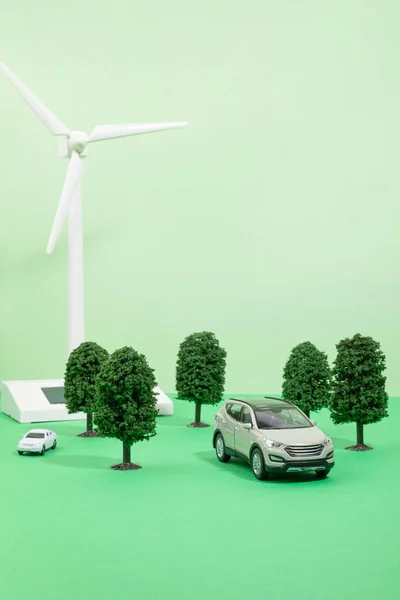 protect earth and environment concept, wind turbines, trees, cars miniatures
