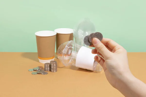 protect earth and environment concept, paper cup and plastic cup and coins, return for cash