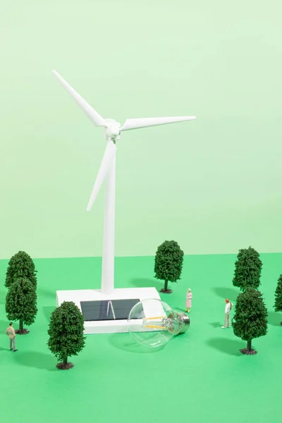 protect earth and environment concept, wind turbine, trees and cars miniatures