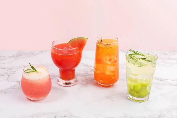 Summer drink background with peach, watermelon, grapefruit, green grapes fruit ades and juices