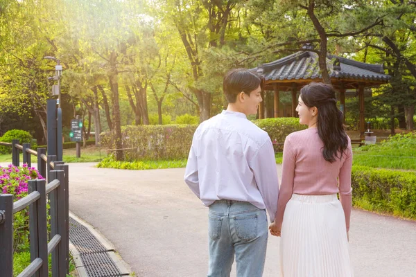 Korean Asian Couple Enjoying Spring Date_Holding Hands — Zdjęcie stockowe