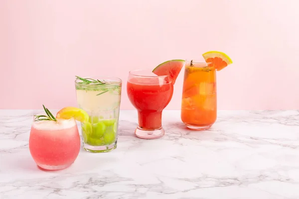 Summer drink background with peach, watermelon, grapefruit, green grapes fruit ades and juices