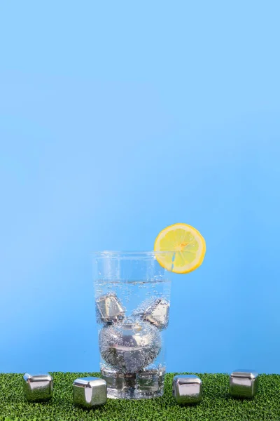 creative summer photo of ice and water cup, blue background