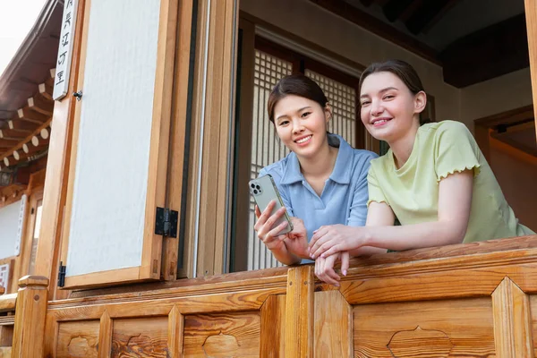 Experience Hanok Korean Traditional House_Korean Caucasian Girls Holding Smartphone —  Fotos de Stock