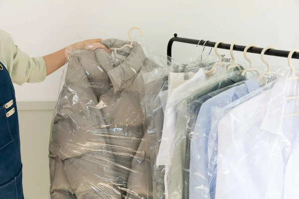 aesthetic laundry concept_clean clothes in plastic bags after dry cleaning