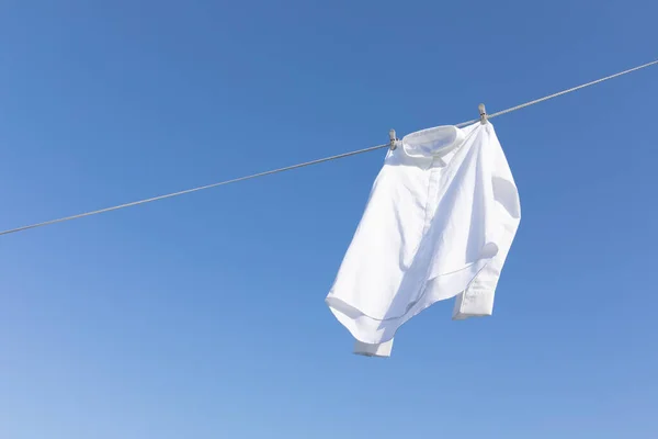 aesthetic laundry concept_shirts hung on a clothesline