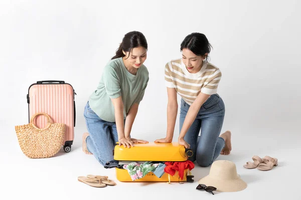 Two Korean Beautiful Young Women Packing Suitcase — Stock Photo, Image