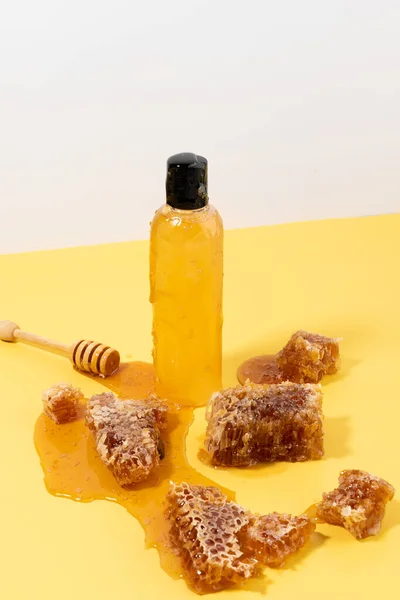 sweet honey in plastic bottle and Wooden Honey Ladle Dipper Stick