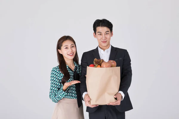 韩国年轻夫妇 男男女女 身穿现代汉博克 手持纸袋 — 图库照片