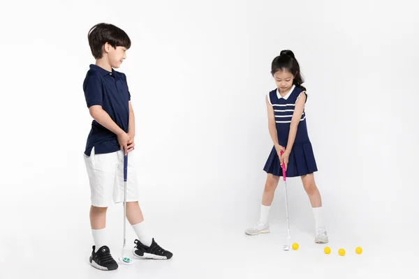 Korean Boy Girl_Fitness Exercise Concept White Background__Swinging Golf Club — Foto de Stock