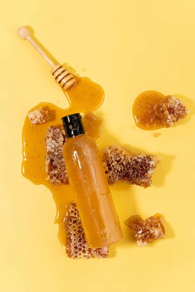 sweet honey in plastic bottle and Wooden Honey Ladle Dipper Stick