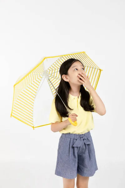 可爱的年轻韩国姑娘 雨季的概念在白色背景工作室里 被大雨惊呆了 — 图库照片