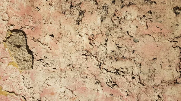 Yıpranmış alçıyla sarımsı duvar dokusu.