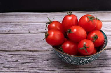 Chopped plane of a set of cherry tomatoes in a bowl.