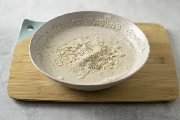 Add salt, baking soda and baking powder. Then add psyllium powder, grind the mass again with a blender. It should become noticeably thicker and denser.