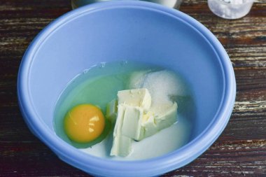 İkinci yumurtadan çıkan bir yumurta ve beyazı bir kaseye koy. Tuz ve şeker ekle. Tereyağını hazırla, tercihen oda sıcaklığında..