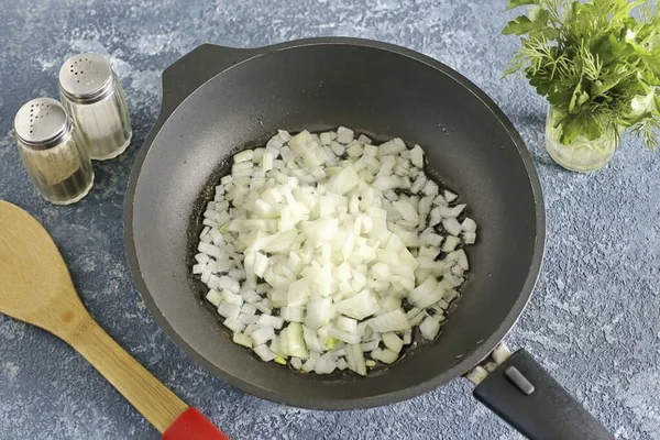 Place the diced onion in a preheated skillet with butter.