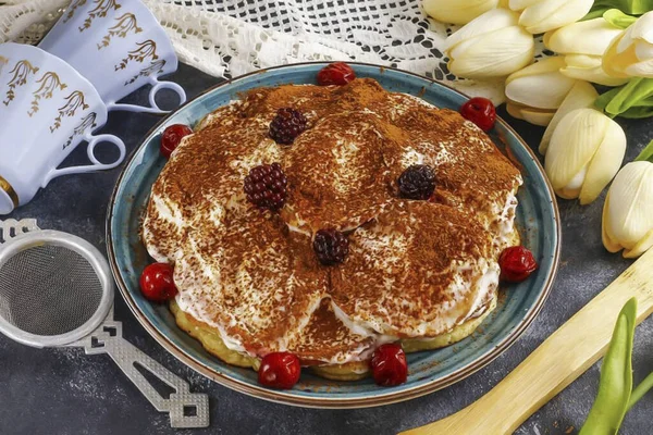 If you do not like to bake cakes, but are very fond of delicious cakes, then just make a cake from pancakes. The dessert will turn out to be no less tasty and its shape will resemble the classic \