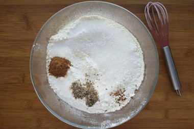 Büyük bir kasede kalan un, şeker, tuz, tarçın, kakule, vanilya, hindistan cevizi ve karanfil karışımı..