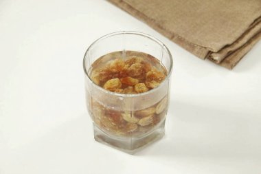 Kuru üzümleri çalkala, üzerine kaynar su dök ve 10 dakikalığına ayrıl. Sonra da kağıt havluya sıvazla..