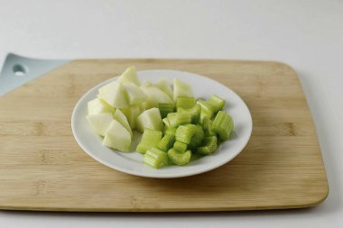 Elmayı soy ve küp küp doğra. Kerevizi yıka, dilimlere böl.